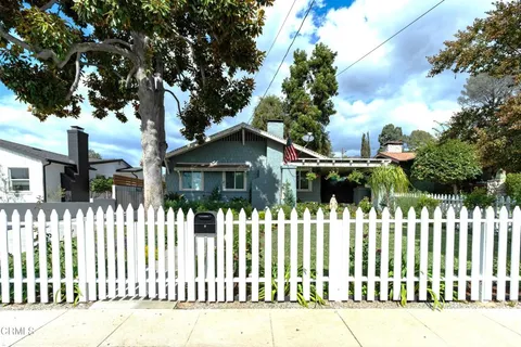 a front view of a house having a garden
