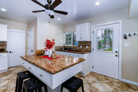 a dining table with a stove and a refrigerator