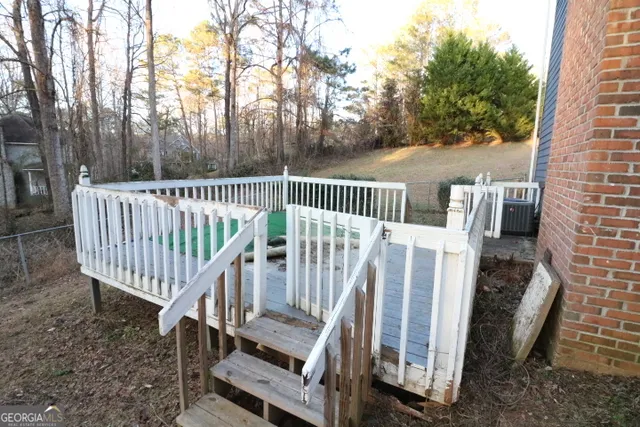 a view of balcony with wooden fence and trees