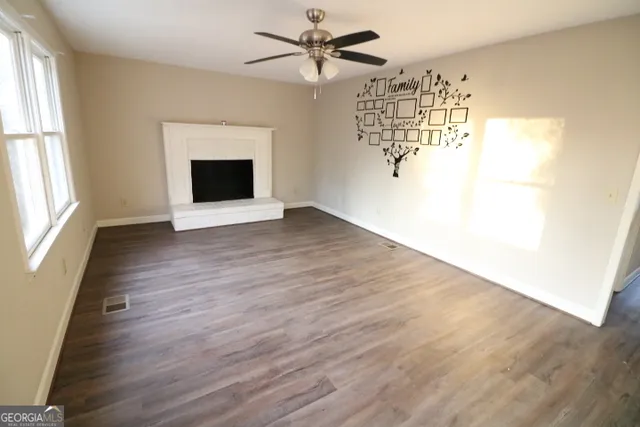 wooden floor in an empty room with a window