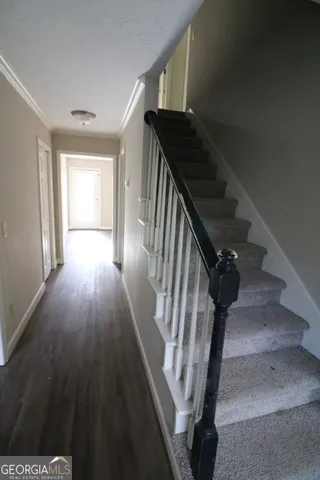 a view of entryway and hall with wooden floor
