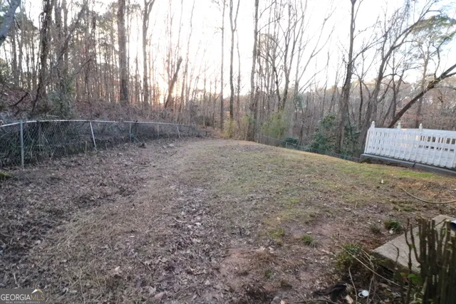 a view of a backyard with large trees