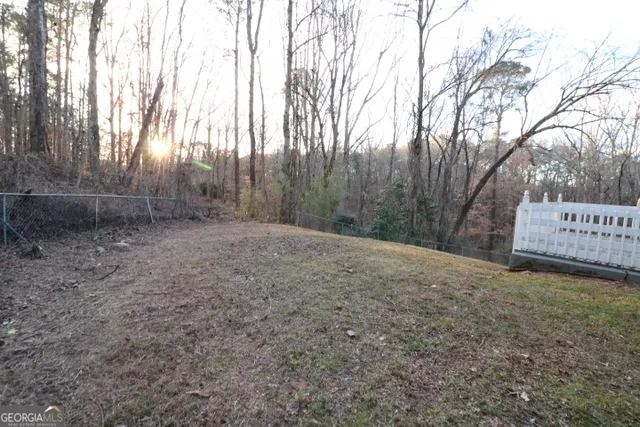 a view of a backyard with large trees