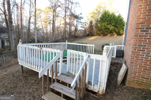 a view of deck with chairs and wooden fence