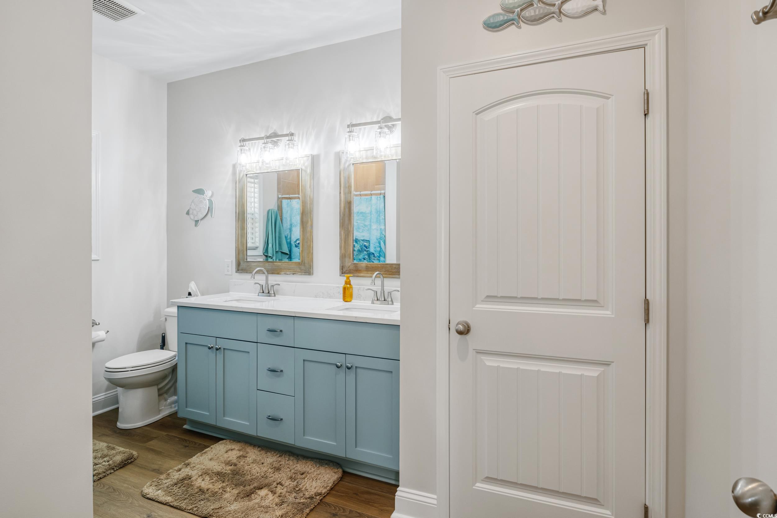 4082 Salem Road Aynor, SC 29511 - Photo 25 of 39 Bathroom with vanity, toilet, and hardwood / wood-