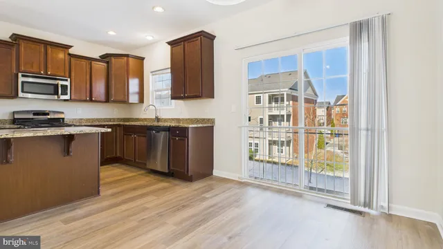 a kitchen with stainless steel appliances granite countertop a stove and a sink