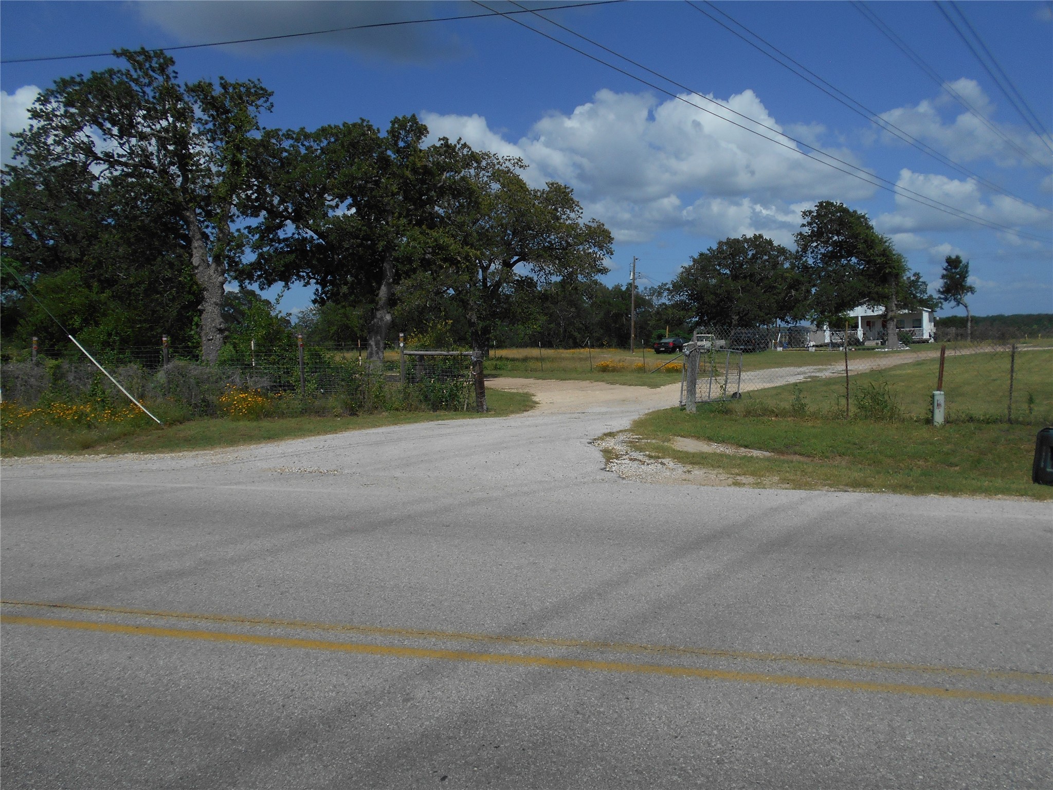 8001 Burleson Manor Road Manor, TX 78653 - Photo 2 of 31 A tranquil country setting offers a paved road approach to a private, tree-lined entry.