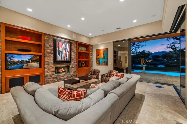 a living room with fireplace furniture and a flat screen tv