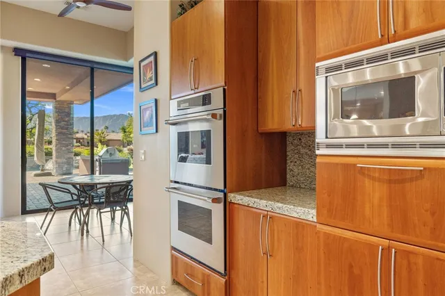 a kitchen with stainless steel appliances granite countertop a refrigerator and microwave