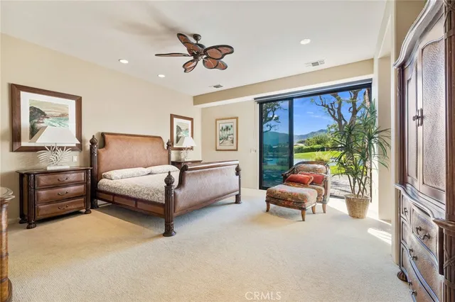 a bedroom with a large bed and a couch