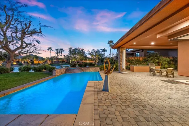 a view of a house with a backyard and a yard