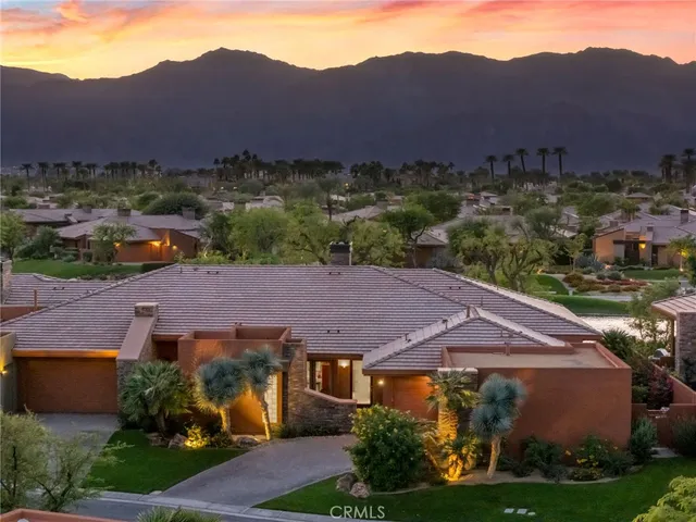 a view of a white house with a yard