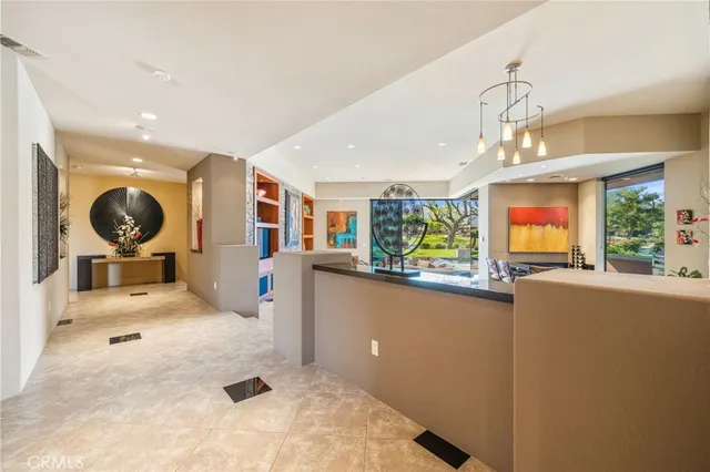 a kitchen view with living room and window