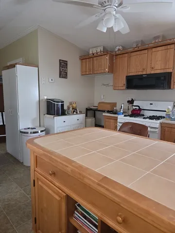 a room with stainless steel appliances a stove a refrigerator and cabinets