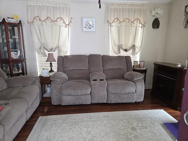a living room with furniture a couch and a window