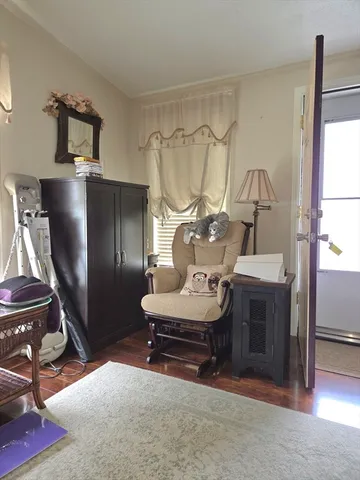 a living room with furniture a desk and chair with wooden floor