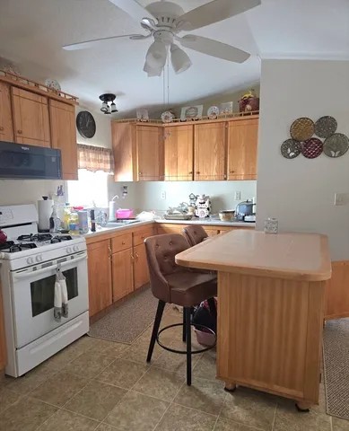 a kitchen with a stove a sink and a microwave