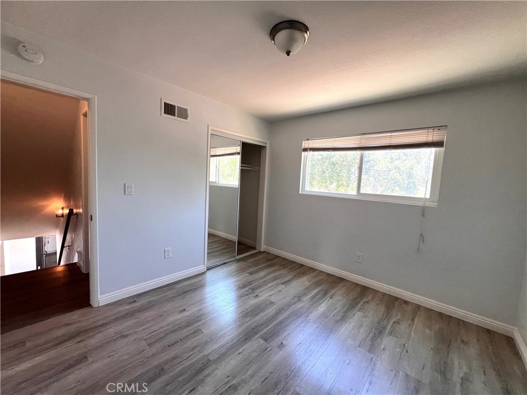 2061 Rancho Drive Riverside, CA 92507 - Photo 13 of 19 an empty room with wooden floor and windows