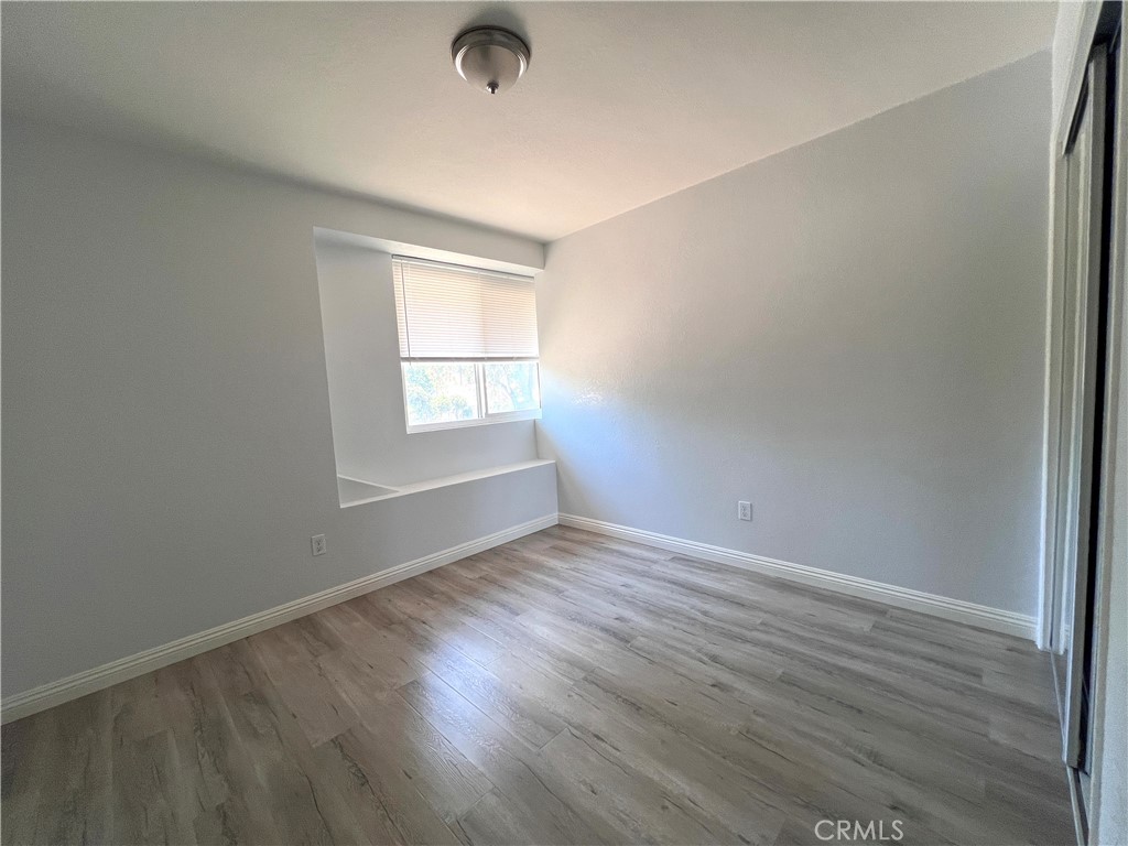 2061 Rancho Drive Riverside, CA 92507 - Photo 16 of 19 an empty room with wooden floor and windows