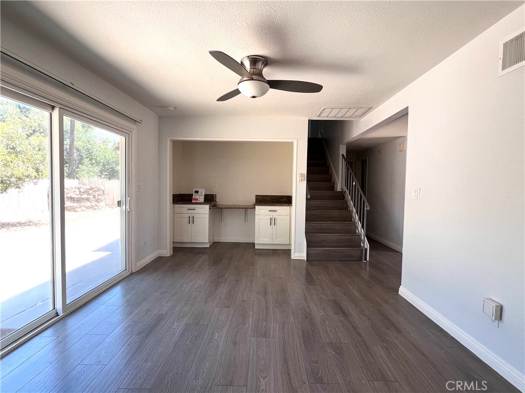 2061 Rancho Drive Riverside, CA 92507 - Photo 3 of 19 a view of a livingroom with wooden floor and a ceiling fan