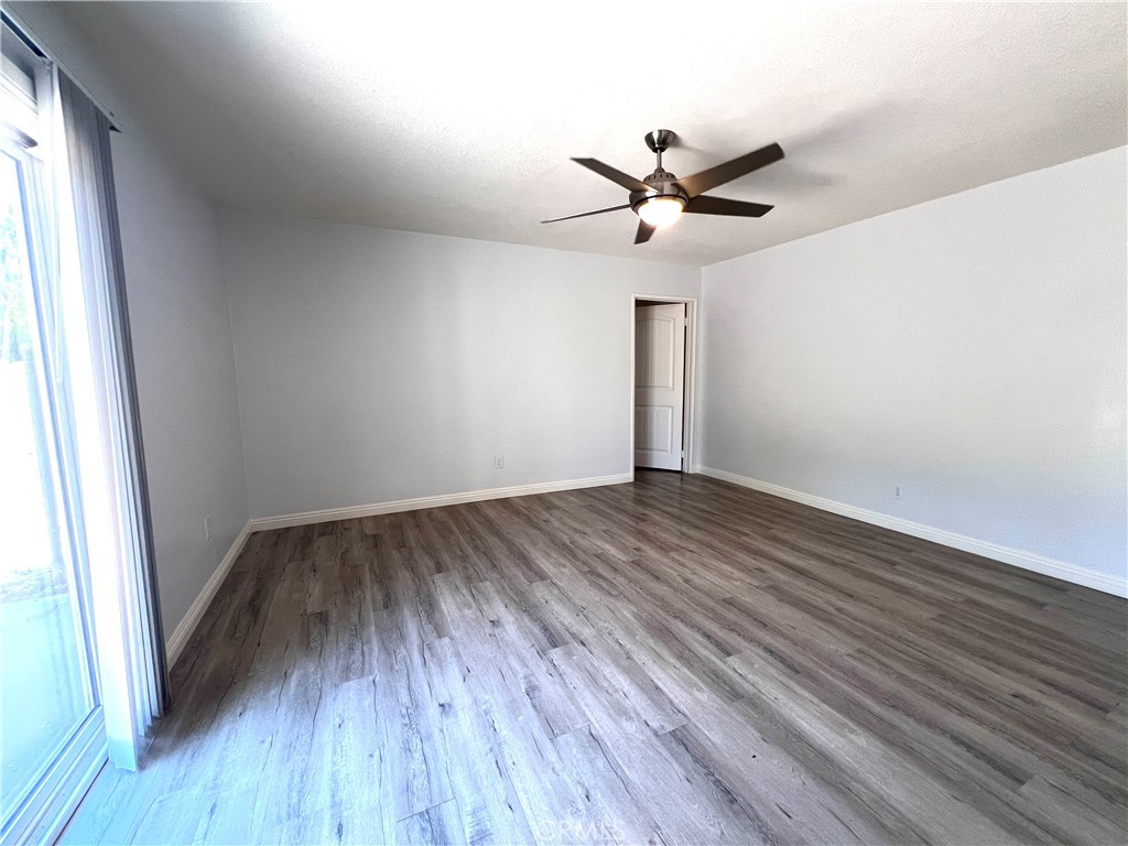 2061 Rancho Drive Riverside, CA 92507 - Photo 6 of 19 an empty room with wooden floor a ceiling fan and closet