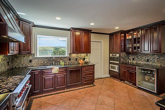 27 Clarendon Road Burlingame, CA 94010 - Photo 7 of 21 a kitchen with stainless steel appliances granite countertop wooden cabinets a stove top oven a sink and dishwasher