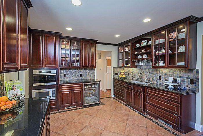 27 Clarendon Road Burlingame, CA 94010 - Photo 10 of 21 a kitchen with stainless steel appliances granite countertop wooden cabinets a sink and a stove
