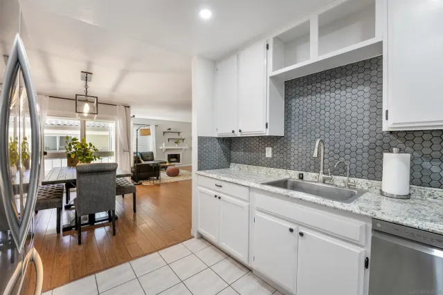 a kitchen with a sink white cabinets and counter space