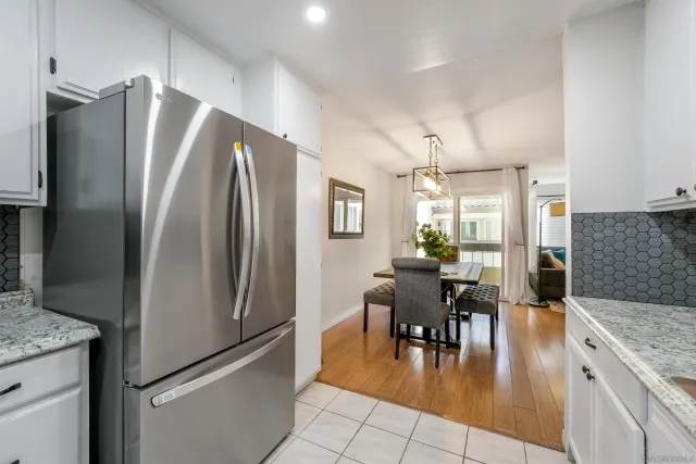a kitchen with stainless steel appliances granite countertop a refrigerator and a stove top oven