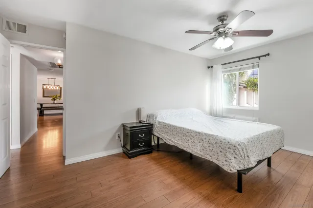 a spacious bedroom with a bed and a chandelier