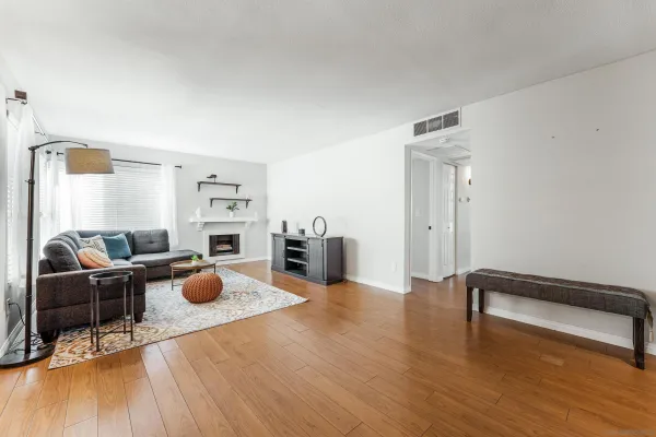 a living room with furniture and a wooden floor