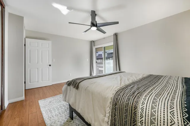 a bedroom with a bed and wooden floor