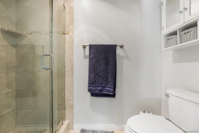 a bathroom with a toilet and a shower