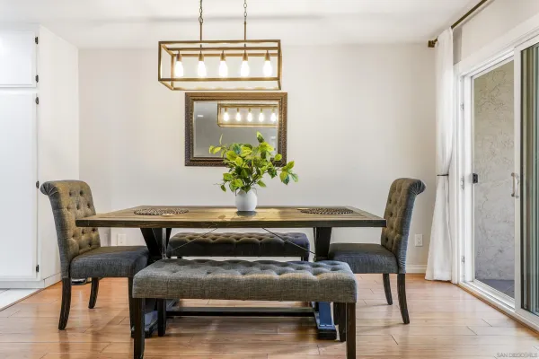a view of a dining room with furniture and wooden floor