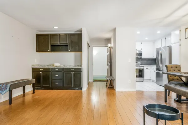 a kitchen with stainless steel appliances granite countertop a stove top oven a sink and a refrigerator