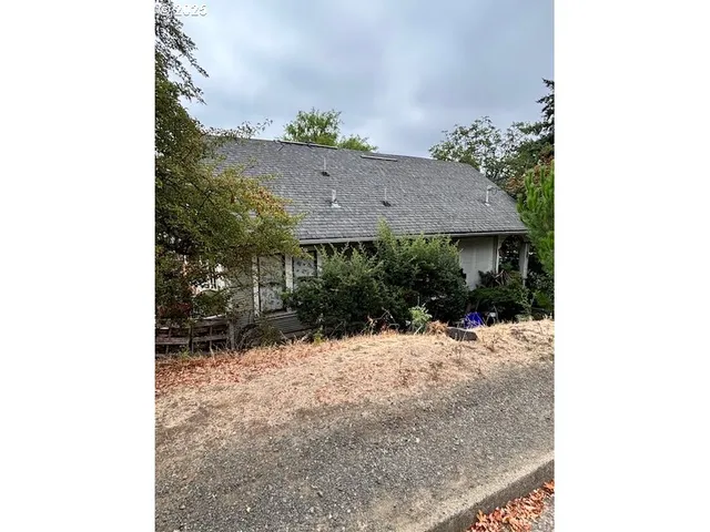 a view of a house with a yard covered with snow in front of it