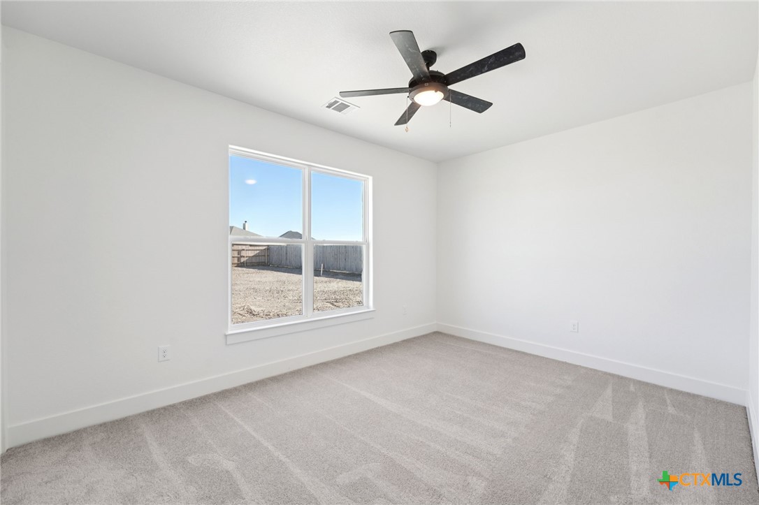 5207 Hollow Ranch Drive Salado, TX 76571 - Photo 30 of 37 an empty room with a ceiling fan and windows