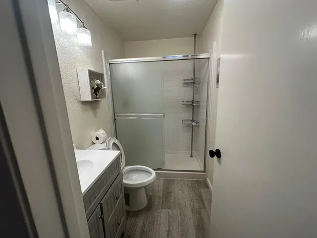 a bathroom with a toilet a sink and shower