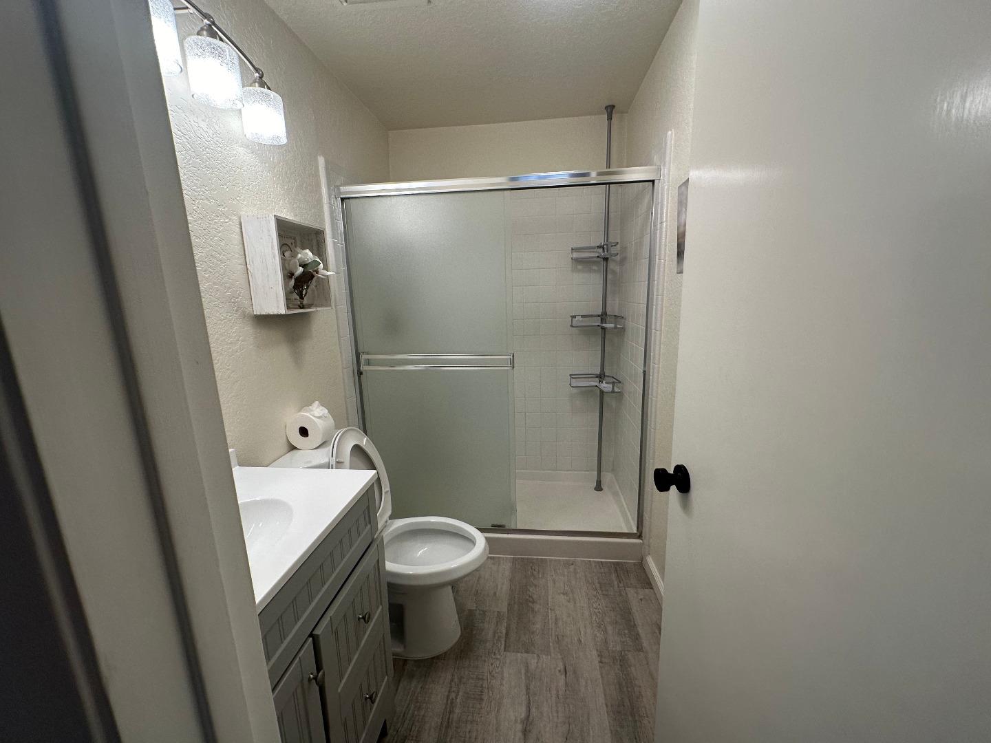 1067 Padre Drive, Unit 1 Salinas, CA 93901 - Photo 11 of 14 a bathroom with a toilet a sink and shower