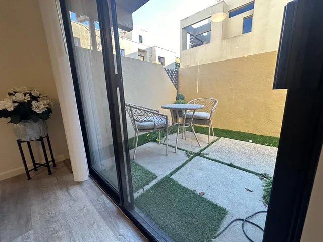 a balcony with table and chairs