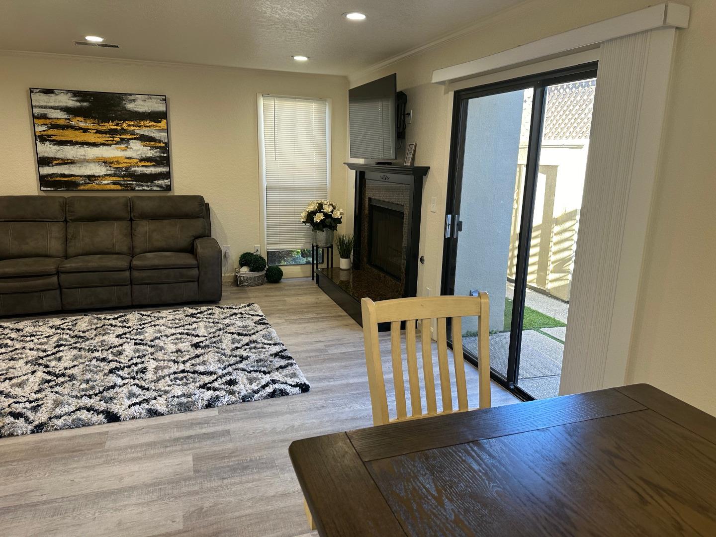 1067 Padre Drive, Unit 1 Salinas, CA 93901 - Photo 7 of 14 a living room with furniture and a flat screen tv