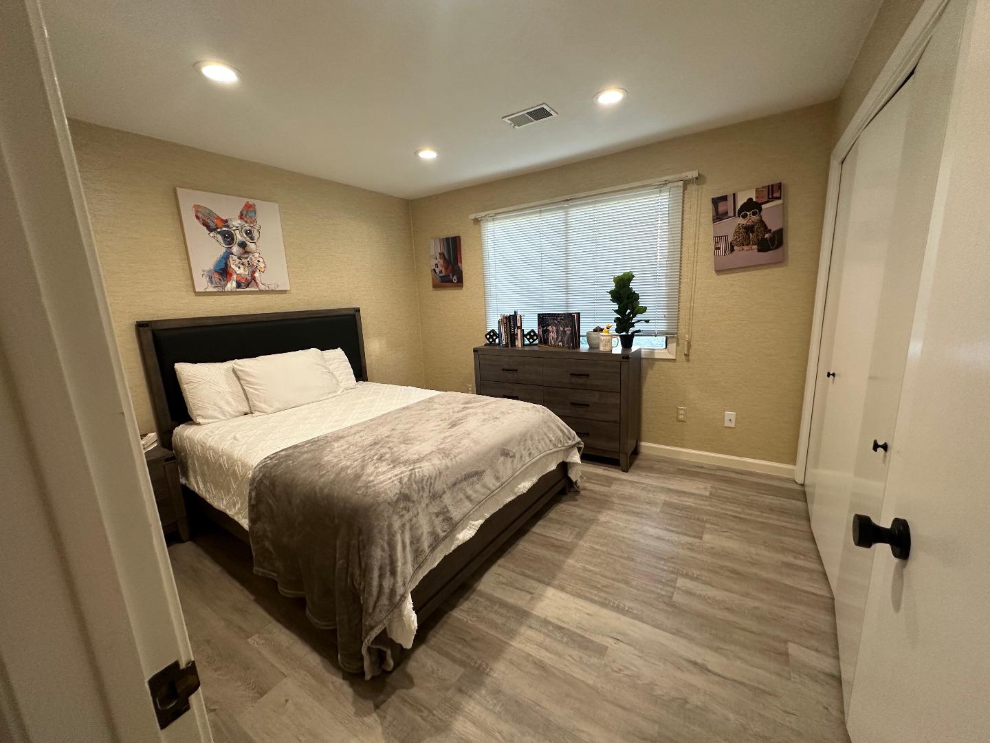 1067 Padre Drive, Unit 1 Salinas, CA 93901 - Photo 9 of 14 a bed room with a bed and a painting