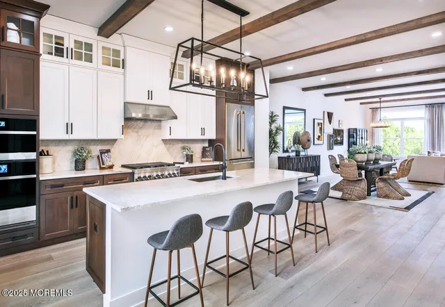 a kitchen with stainless steel appliances granite countertop a stove and white cabinets