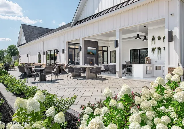a view of a patio with table and chairs potted plants