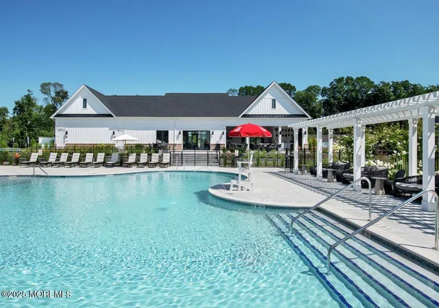 a view of a swimming pool with seating space