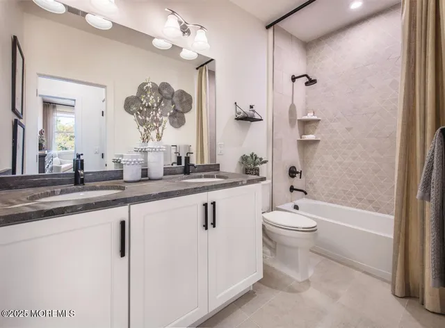 a bathroom with a double vanity sink toilet and shower