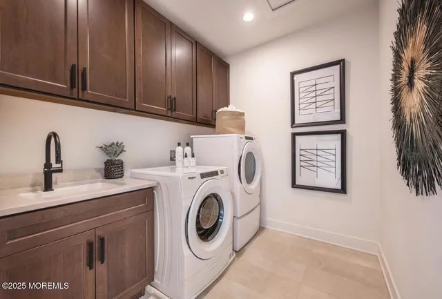 a utility room with sink dryer and washer
