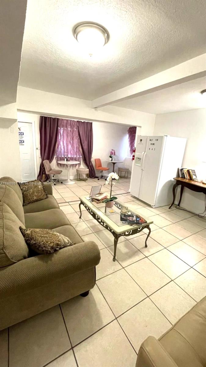 3 Southwest 7th Avenue Dania Beach, FL 33004 - Photo 11 of 25 a living room with furniture and a table