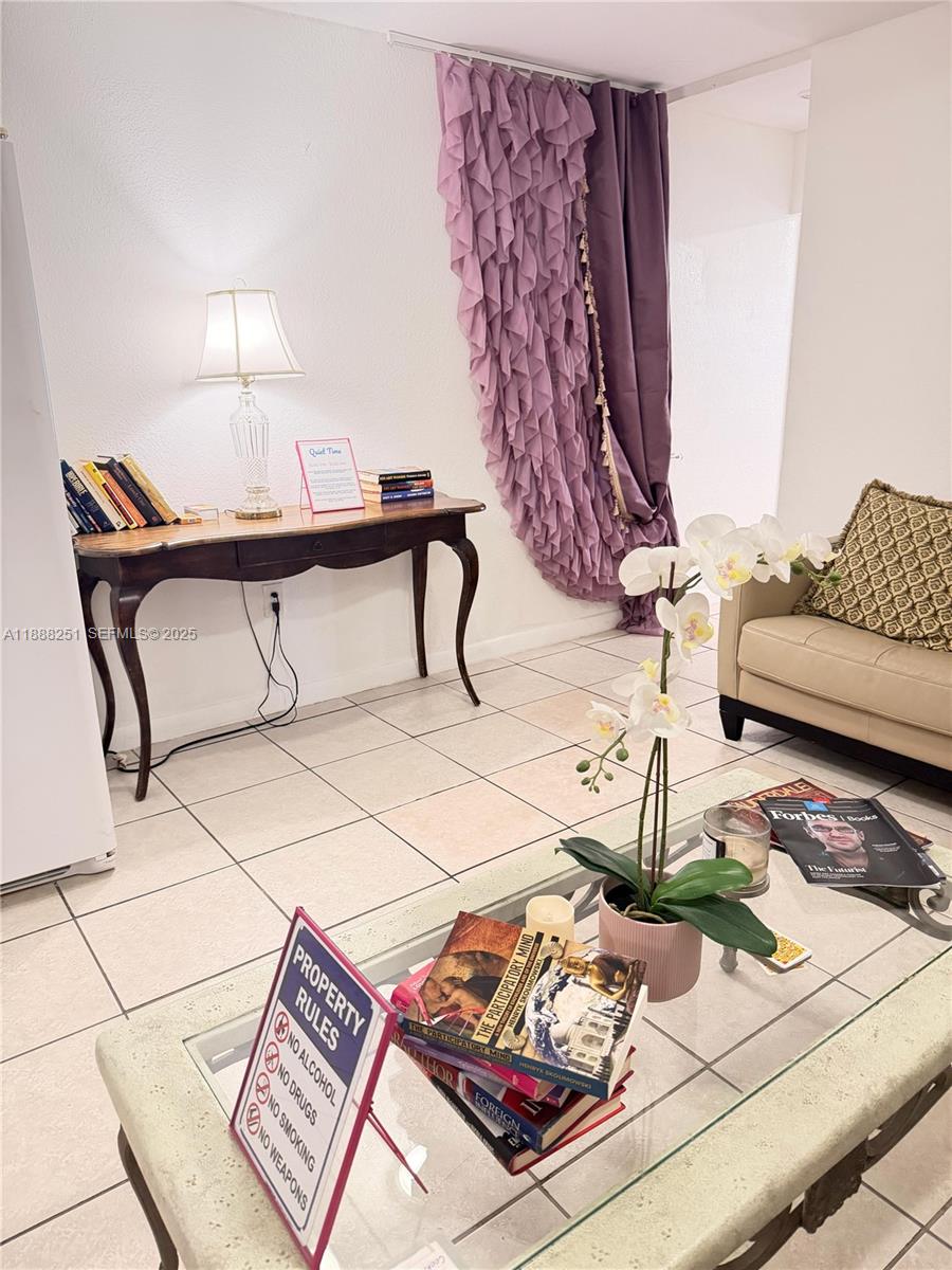 3 Southwest 7th Avenue Dania Beach, FL 33004 - Photo 12 of 25 a living room with a couch and a rug