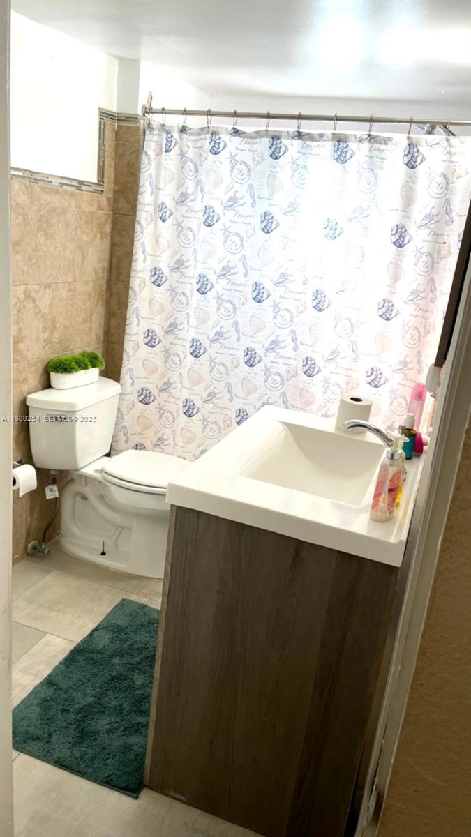 3 Southwest 7th Avenue Dania Beach, FL 33004 - Photo 16 of 25 a bathroom with a sink and a mirror